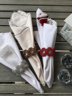 four napkins are sitting on top of each other with beaded decorations around them