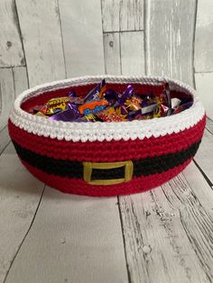 a crocheted basket filled with assorted candy