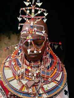 an african woman with elaborate headdress and jewelry