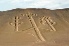 two crosses carved in the sand on top of a hill