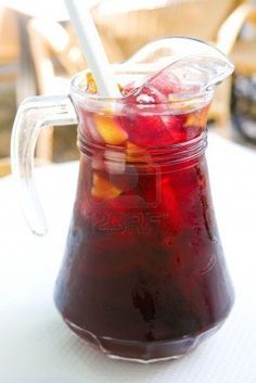 a pitcher filled with liquid sitting on top of a table