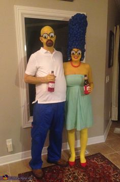 a man and woman dressed up as simpsons and homer from the simpsons show standing next to each other