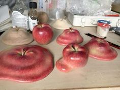 some apples are sitting on a counter top