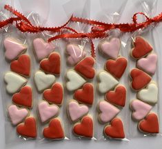 several heart shaped cookies in plastic bags on a table