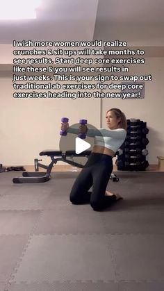 a woman is sitting on the floor with her legs crossed and holding two cups in one hand