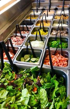 many trays filled with different types of food