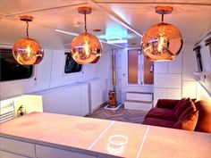 the inside of a house with three disco ball lights hanging from it's ceiling