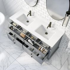 a bathroom with two sinks and mirrors on the wall