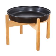 a wooden stand with a black bowl on it