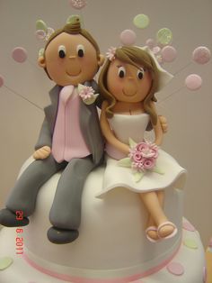 a wedding cake with a bride and groom on top