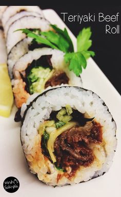 there is a sushi roll with meat and veggies on it