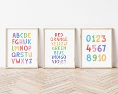 three framed art prints with different colors and numbers on the wall next to each other