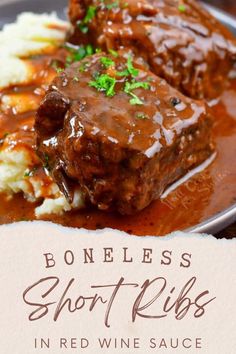 two meatballs covered in gravy on top of mashed potatoes