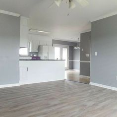 an empty living room with hard wood floors