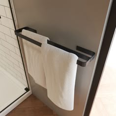 a towel rack in the corner of a bathroom