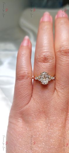 a woman's hand with a diamond ring on it