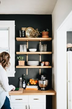 a woman standing in front of a kitchen counter