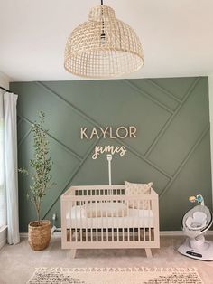 a baby's room decorated in green and white