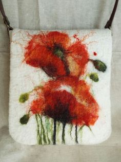 a purse with red flowers painted on it