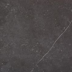 a black marble floor with cracks in the middle and white streaks on it's surface