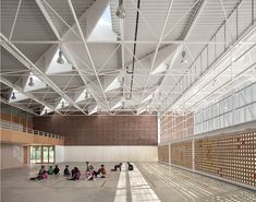 people are sitting on the floor in an empty building