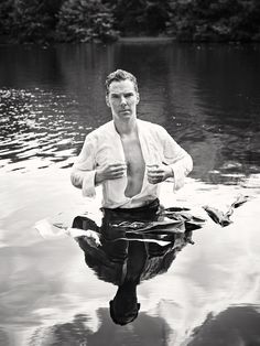 a man standing in the water with his shirt on