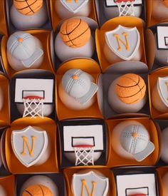 basketball themed cakes are arranged in boxes with the letter n on them, along with other sports related items