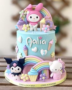 a hello kitty themed cake on a wooden table