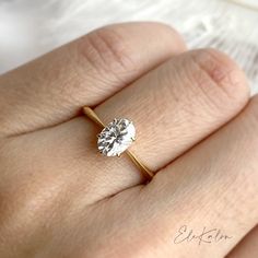 a woman's hand with a diamond ring on it