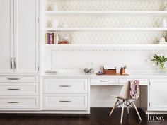 a white desk and some shelves in a room