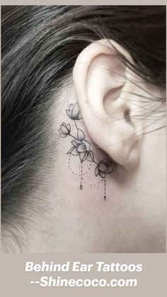 a woman's behind the ear has a small flower tattoo on her left side