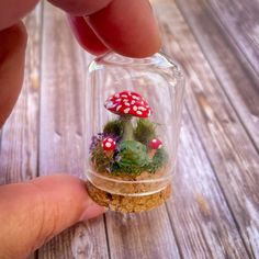 This listing is for this very small enclosed toad and mushroom scene. It is made with natural bits of moss, faux plants along with polymer clay mushrooms and a hand painted frog and mushroom made from resin. It is enclosed in a glass cloche and has a cork base. The glass is glued down and sealed, as are all the contents inside. It measures 45mm, or 1.75 inches tall and 30mm, or just over an inch wide. These tiny scenes are all handmade, and as such no two will look exactly the same. This little Clay Miniatures Diy, Polymer Clay Plants, Mossy Mushroom, Toad Mushroom, Mushroom Scene, Mushroom Terrarium, Terrarium Scene, Painted Frog