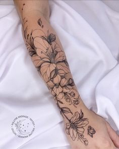 a person with a flower tattoo on their arm