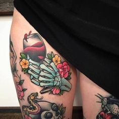 a woman's thigh with tattoos on it