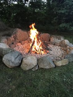 a fire pit with rocks and gravel around it