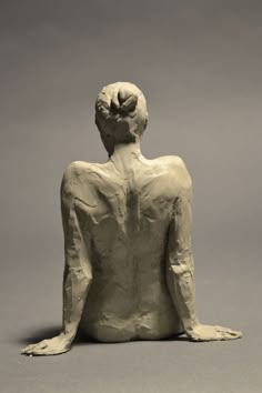 a white sculpture sitting on top of a gray floor next to a black and white wall