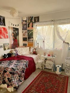 a bed room with a neatly made bed and lots of pictures on the wall