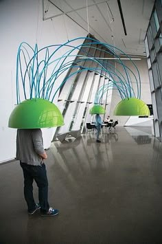 a man standing in an office with green lamps on his head