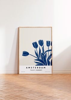 a blue and white poster with flowers on the wall in front of it is an empty room