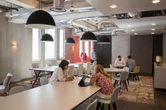 people sitting at tables in an office setting