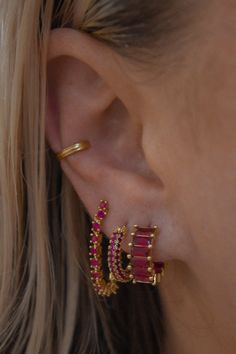 For the babes who love to sparkle, the Ruby Red Pave Hoop is a must. Red crystals cover this hoop and shine just right. 14mm x 3mm Gold plated over brass and finished with an IP tarnish resistant coating Surgical steel posts for sensitive ears Nickel and cadmium free by LUV AJ Ruby Ear Piercings, Red Earring Stack, 3 Earring Stack, Red Piercing, Ruby Red Jewelry, Dream Piercings, Ear Peircings, Earring Stack, Piercing Inspo