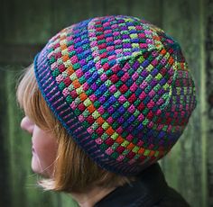 a woman wearing a multicolored knitted hat