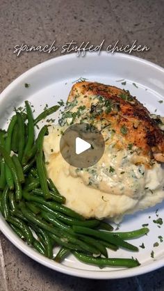 a white plate topped with mashed potatoes and green beans