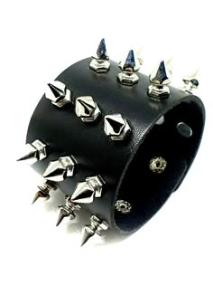 Edgy and bold, this Spike Cuff Wrist Bracelet features 21 rivet studs on faux vegan leather, perfect for punk, goth, emo, and rocker styles! Adjustable press stud closure fits wrists up to 8” circumference. Crafted from black, nickel-free materials, it's designed for special occasions and daily wear alike. Ideal for gifting on birthdays, anniversaries, and holidays. Make a statement with this unisex accessory! Key features: - 21 spike rivet cuff - Vegan faux leather - Adjustable press stud - Fits wrists up to 8” - Nickel-free Order now and amp up your style! 21 Spike Rivet Cuff Press Stud Bracelet Faux Leather Approx 8.75" x 2" (22 cm x 5 cm) (220 mm x 50 mm) Approx 0.62" x 0.35" (1.6 cm x 0.9 cm) (16 mm x 9 mm) Hexagonal To Point Rivet Stud Spike Faux Vegan Leather Bonded Black Punk, Goth Punk Patches, Black Punks, Wrist Bracelet, Black Bracelet, Jewelry Accessories Ideas