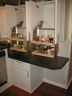 an open cabinet in the middle of a kitchen filled with food and condiments