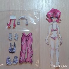 an image of a doll with clothes and accessories on display in a plastic package for dolls