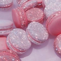 several pink and white round shaped objects with glitter on them are arranged in a circle