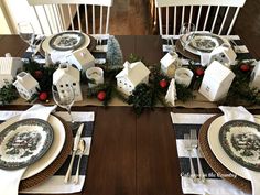 a table set for christmas with plates and silverware