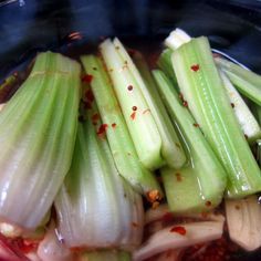 celery and onions are in a bowl with seasoning on the side, ready to be cooked