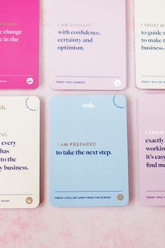 four notebooks with quotes on them sitting next to each other in front of a pink background